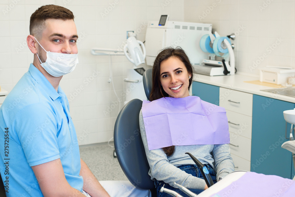 The dentist scans the patient's teeth with a 3d scanner. The dentist scans the patient's teeth with a 3d scanner.