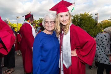 Grandmother poses for photo with high school graduate granddaughter