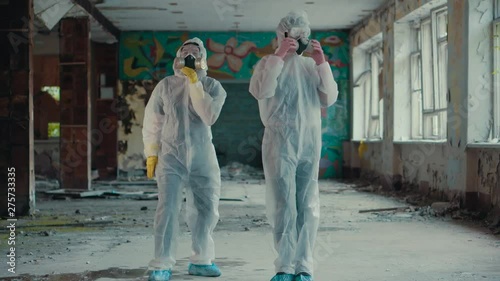 Scientists put on respirators and dance for a rap clip. Girls in a protective suit from radiation moving to the music. Environmental theme. Terrible abandoned territory in Novosibirsk.