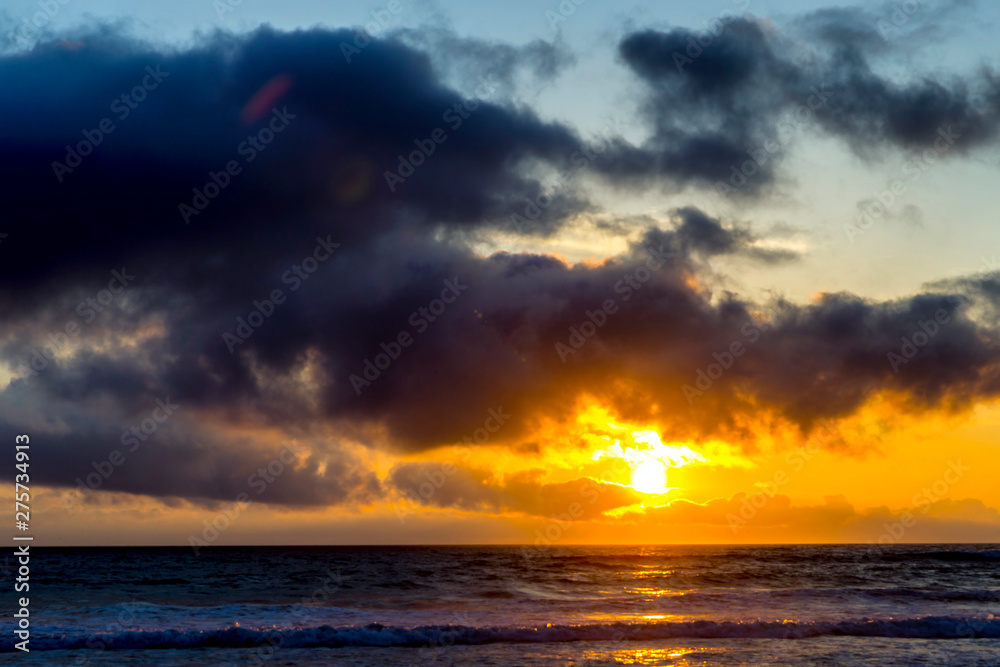 Sunset over Ocean with Dark Clouds