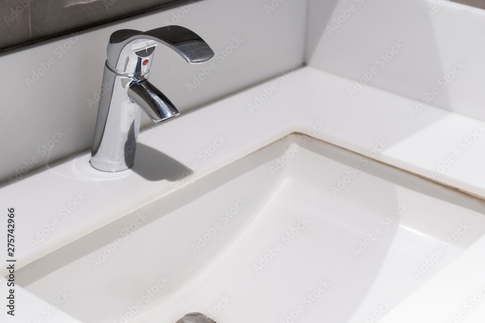 Fototapeta premium Modern faucet with wash basin sink counter bathroom interior contemporary