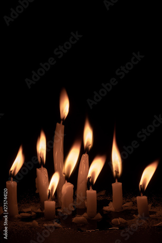 Mourning concept. Light candles white on black background. Selective focus.