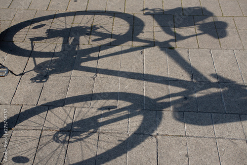 Shadow of Mountain Bike on Brick pavers in hot summer sun