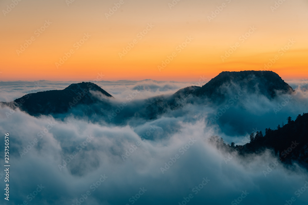 View of marine layer low clouds over Los Angeles at sunset, from Mount Wilson, in Angeles National Forest, California View of marine layer low clouds over Los Angeles at sunset, from Mount Wilson, in Angeles National Forest, California