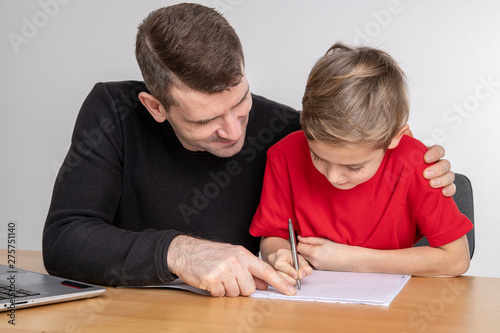 father helping his son with homework