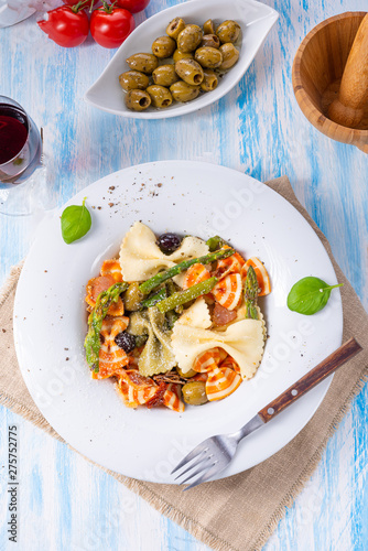 colorful farfalle with green asparagus olives and parma ham