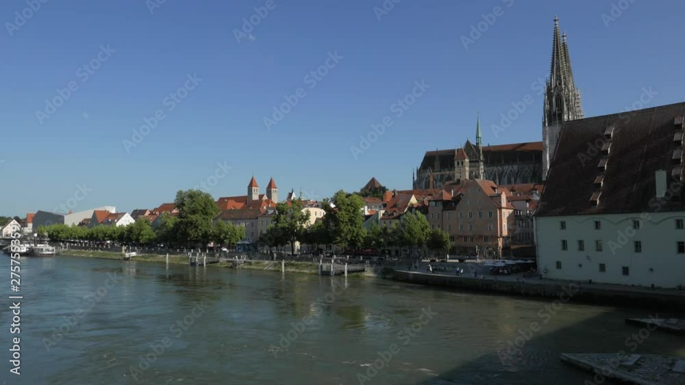 REGENSBURG, GERMANY - JUNE 13, 2019: Regensburg cityscape as viewed from the medieval Stone Bridge over the Danube river. The medieval center of the city is a UNESCO World Heritage Site. REGENSBURG, GERMANY - JUNE 13, 2019: Regensburg cityscape as viewed from the medieval Stone Bridge over the Danube river. The medieval center of the city is a UNESCO World Heritage Site.
