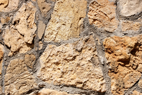 Texture. Stone masonry of an ancient fortress. Retro or grunge texture. Abstract image of a stone wall. Bright background.