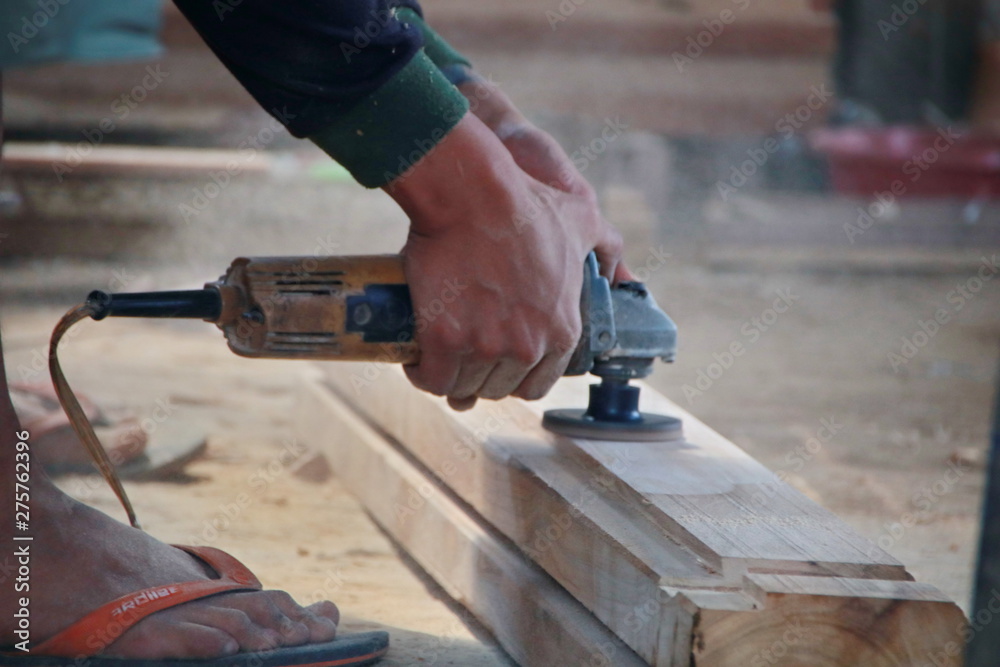 Carpenters work on woodworking machinery in carpentry shops Carpenters work on woodworking machinery in carpentry shops