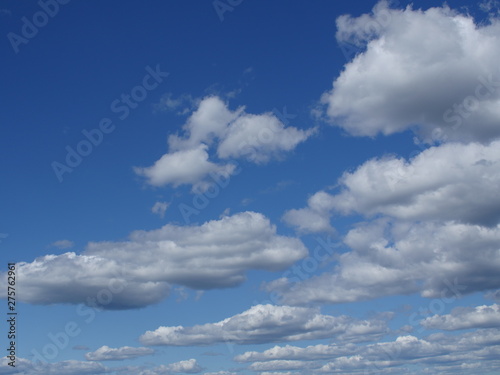 fluffy cumulus clouds in blue sky skyscape