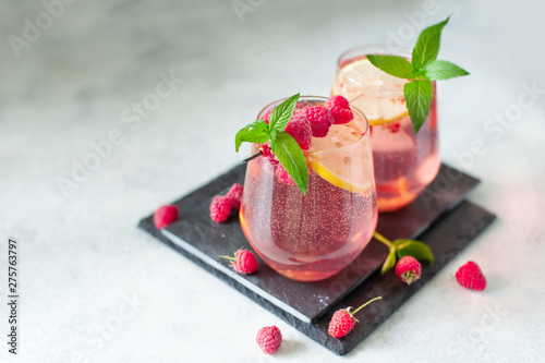 Sparkling pink raspberry lemonade on grey background