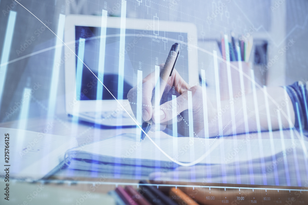 Financial forex charts displayed on woman's hand taking notes background. Concept of research. Double exposure Financial forex charts displayed on woman's hand taking notes background. Concept of research. Double exposure