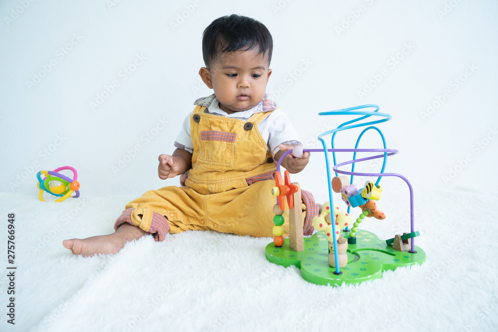 cute little asin baby boy playing with wooden toy at room cute little asin baby boy playing with wooden toy at room
