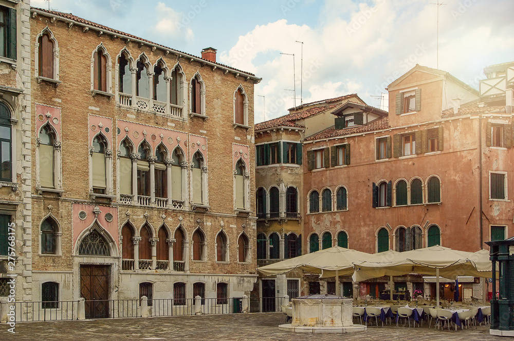 Outdoors in Venice. Old antique houses and cafes
