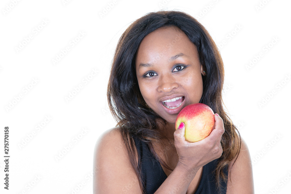 healthy african american young woman biting a red apple healthy african american young woman biting a red apple
