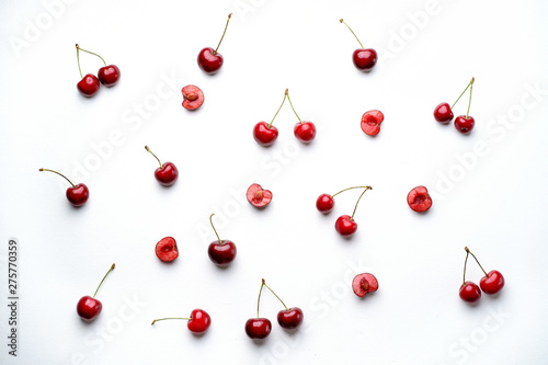 Cherry pattern. Creative summertime berry layout. Flat lay of fresh ripe cherries on white background. Top view