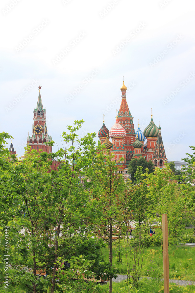 Zaryadye park on summer day with Kremlin tower with Saint Basil Cathedral on Red Square in Moscow, capital city of Russia 