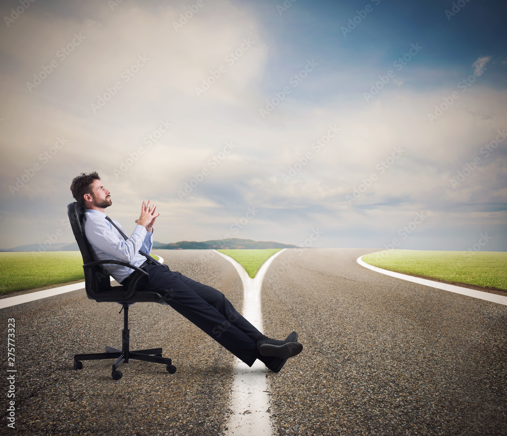 Difficult choices of a businessman at a crossroads. concept of confusion Difficult choices of a businessman at a crossroads. concept of confusion