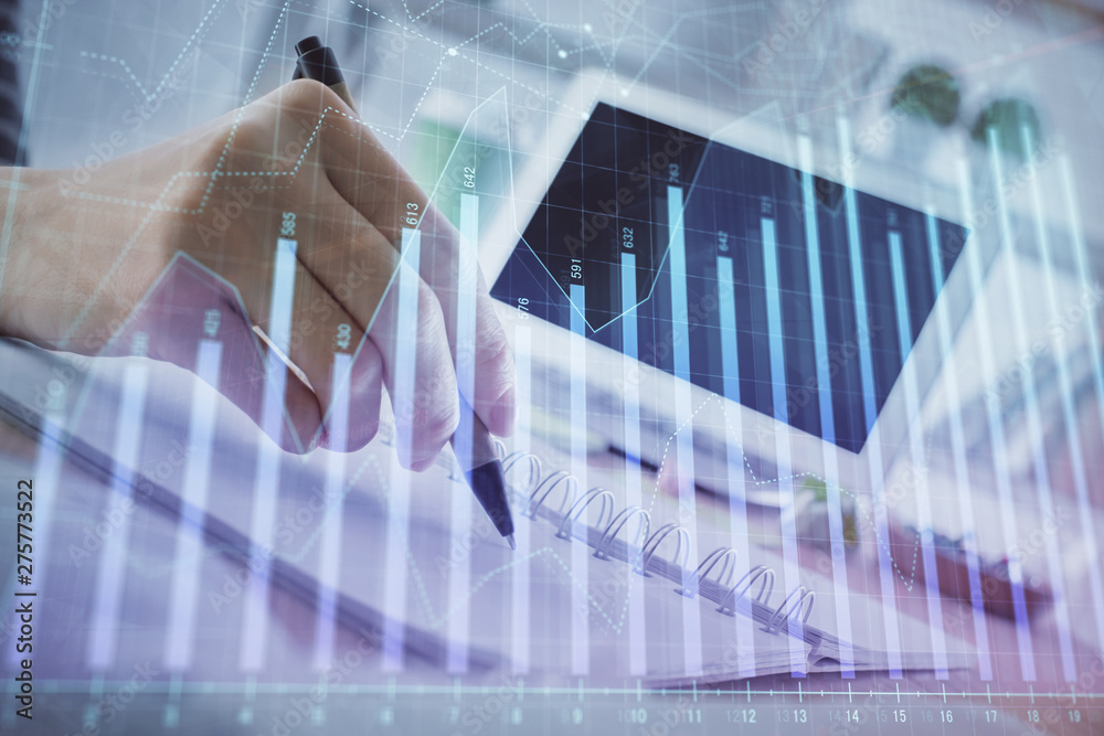 Financial forex graph drawn over hands taking notes background. Concept of research. Multi exposure Financial forex graph drawn over hands taking notes background. Concept of research. Multi exposure
