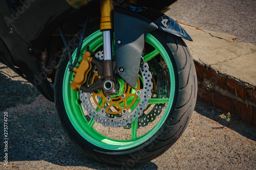 black sports bike with green wheels front wheel photo