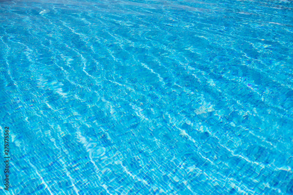 Blue swimming pool rippled water detail. Background