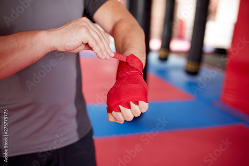 Boxer putting handwraps on