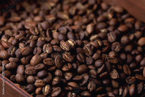 natural coffee beans in a wooden box on a natural wooden background  soft backlight