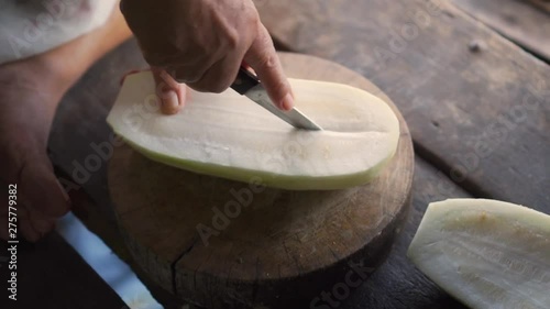 Winter melon get split in half with knife. Ingredient for cooking soup.
