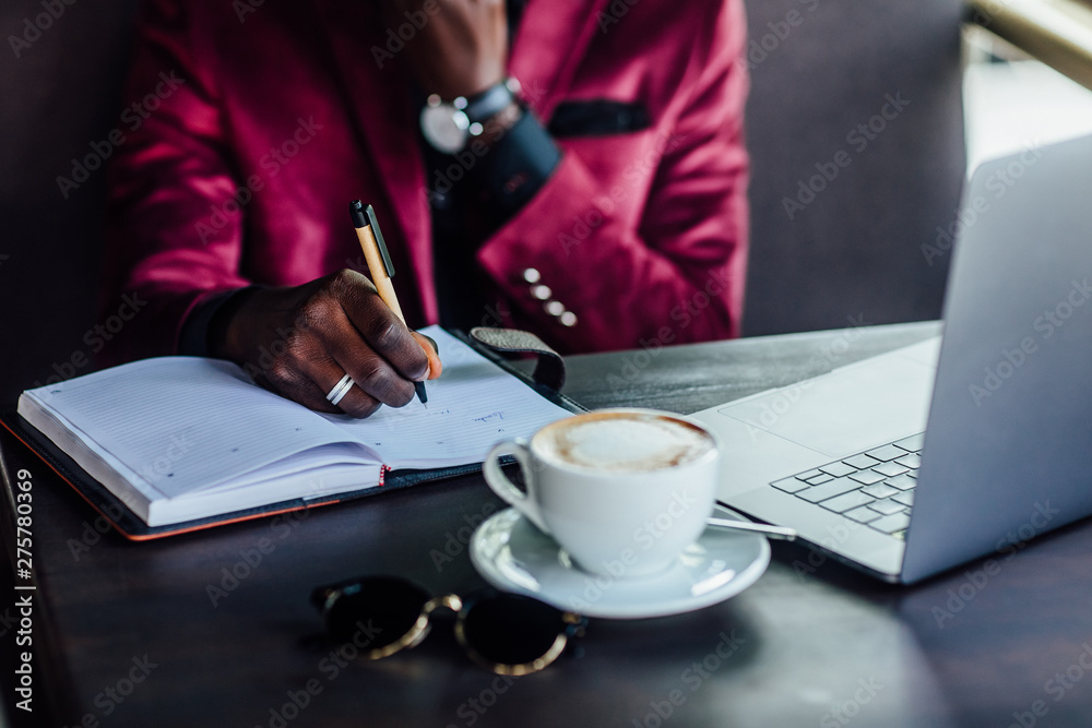 Close up photo. Business man writing notes in caffee shop. Business concept. Close up photo. Business man writing notes in caffee shop. Business concept.