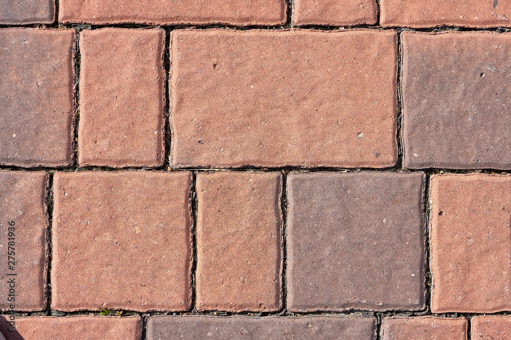 Obraz premium Red Brick Flooring. Top View of Red Bricks Paving Stones Footpath on a Sidewalk Outdoors as Brickwork Weaved Texture or Abstract Stone Paver Herringbone Template Background