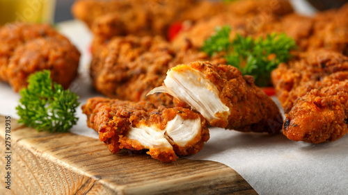фотографія Breaded chicken strips with beer, ketchup and mayonnaise on wooden board