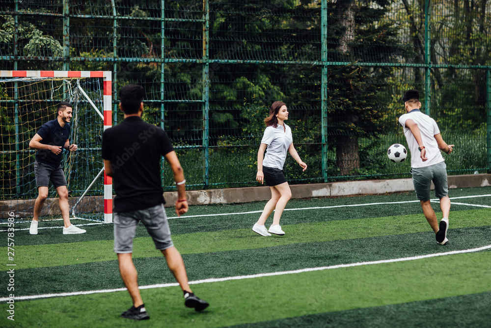 Portrait of male and female, adult soccer teams playing together on field. Football concept.. Portrait of male and female, adult soccer teams playing together on field. Football concept..