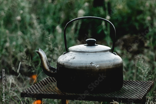 old teakettle over open fire in the african bush