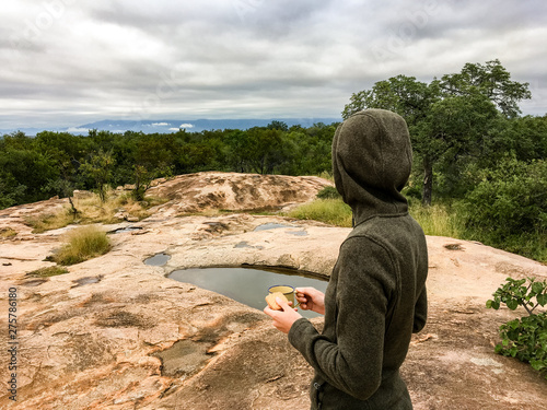 Woman in the african bush with clouds