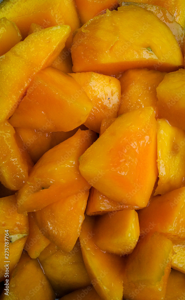yellow mango fruit cut into small pieces slices , seasonal fruit, background wallpaper yellow mango fruit cut into small pieces slices , seasonal fruit, background wallpaper