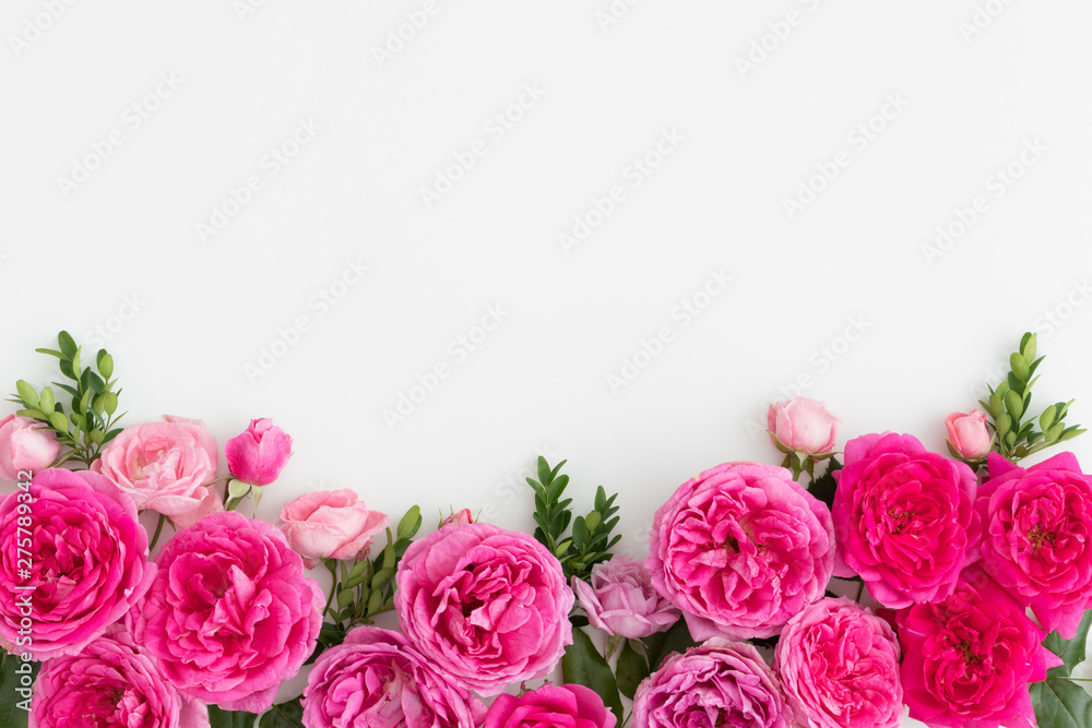 Pink roses on a white table. Flat lay with blank copy space.