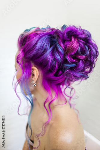 Portrait of a young beautiful woman with colored hair. Bright shades of blue and purple, gradient hair.
