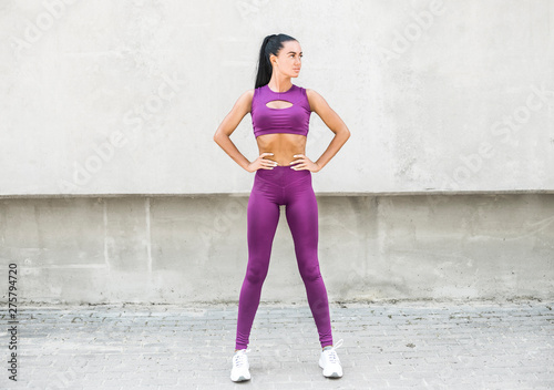 Young beautiful woman athlete in leggings. Fitness trainer.