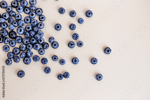 Pattern, top view, background with berries. Blueberry on light pastel background. Tasty raw vegetarian food. 