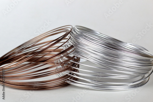 Two bays of silver and copper wire located on a light background.