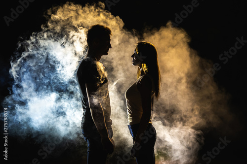 The silhouette of man and woman in the smoke
