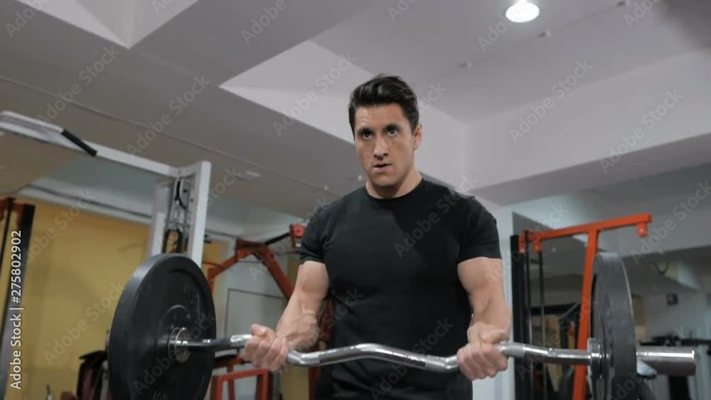 Bodybuilder pumping muscle in the gym, do fitness Bodybuilder pumping muscle in the gym, do fitness