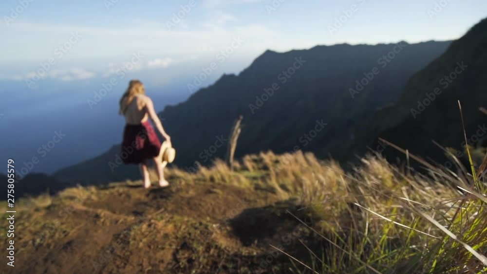 Slow Motion: Woman Walking By Edge Of Sunny Mountain, Kauai, Hawaii Slow Motion: Woman Walking By Edge Of Sunny Mountain, Kauai, Hawaii