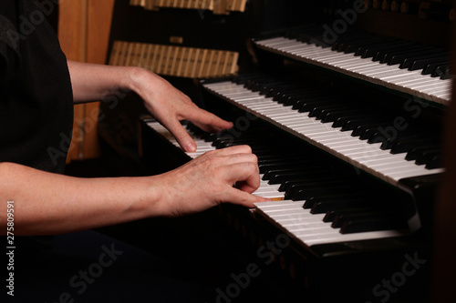Organist playing a pipe organ, closeup view