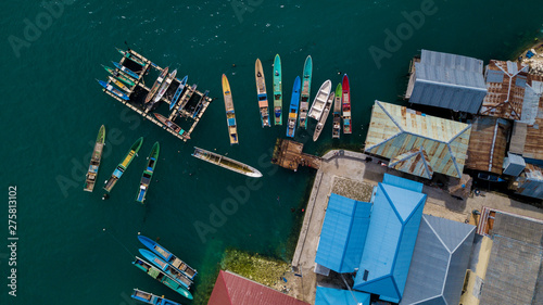 Aerial view or bird view of jetty with many wooden boats are docking © sahabatransel