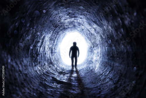 Senior Man Walking To The Light At The End Of The Tunnel - Hope After Life photo