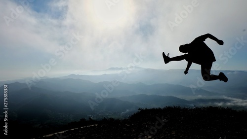 silhouette of man jumping against sky