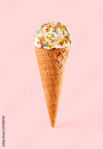 White ice cream ball in a Waffle Cone on a pink Background. Fruit ice cream in a waffle cone.