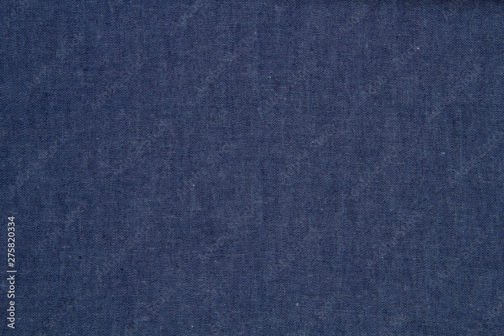 The fabric of blue jeans background texture The fabric of blue jeans background texture