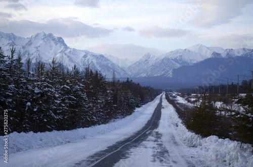 winter evening road to mountains photo